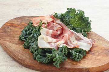 Raw pork bacon over board