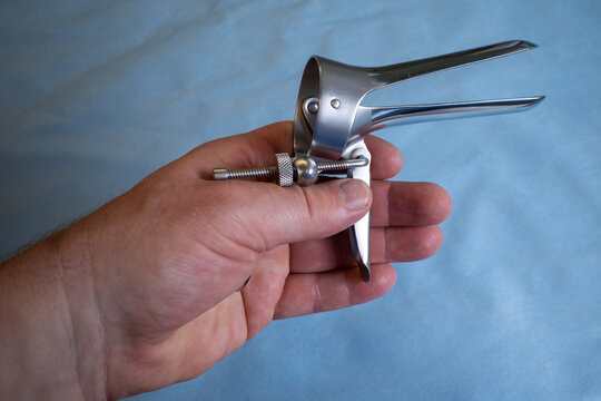 in a hand is a speculum for a gynecological examination