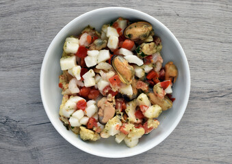 Mixed frozen seafood isolated on wooden background