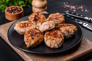 Delicious fresh fried minced meat patties on a dark concrete background