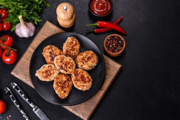 Delicious fresh fried minced meat patties on a dark concrete background