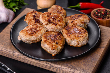 Delicious fresh fried minced meat patties on a dark concrete background