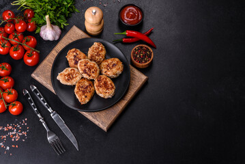 Obraz na płótnie Canvas Delicious fresh fried minced meat patties on a dark concrete background