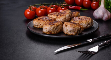 Delicious fresh fried minced meat patties on a dark concrete background