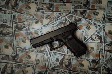 Criminal money. Pistol on dollar banknote background. Top view. Mafia and corruption concept. black...