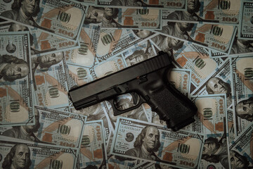 Criminal money. Pistol on dollar banknote background. Top view. Mafia and corruption concept. black money and protection