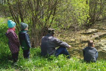 Group of people at the lake fishing on a sunny day