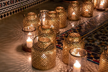 Copper lanterns with candles at night with grain and out of focus