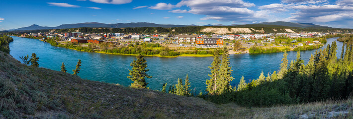 Panorama of the city of Whitehorse, Canada, with the Yukon river in the foreground - obrazy, fototapety, plakaty