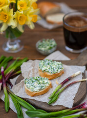 Bruschetta with garlic butter. Breakfast with fresh wild garlic. Spring seasonal products concept