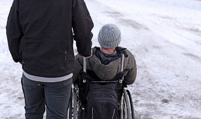 Sundsvall, Norrland Sweden - October 30, 2019: man in wheelchair with companion by his side