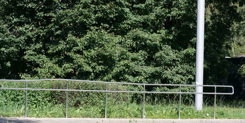 metal fence in park at dry sunny summer day