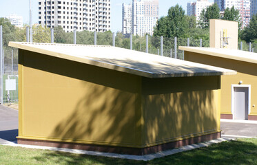 small yellow building near football field at day sunny day