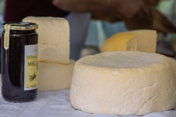 honey and fresh cheese on market stall