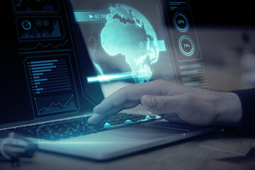 Obraz premium Close up of hand using notebook with creative glowing digital business screen interface, globe and charts on blurry background. Spy, hud and world concept. Double exposure.