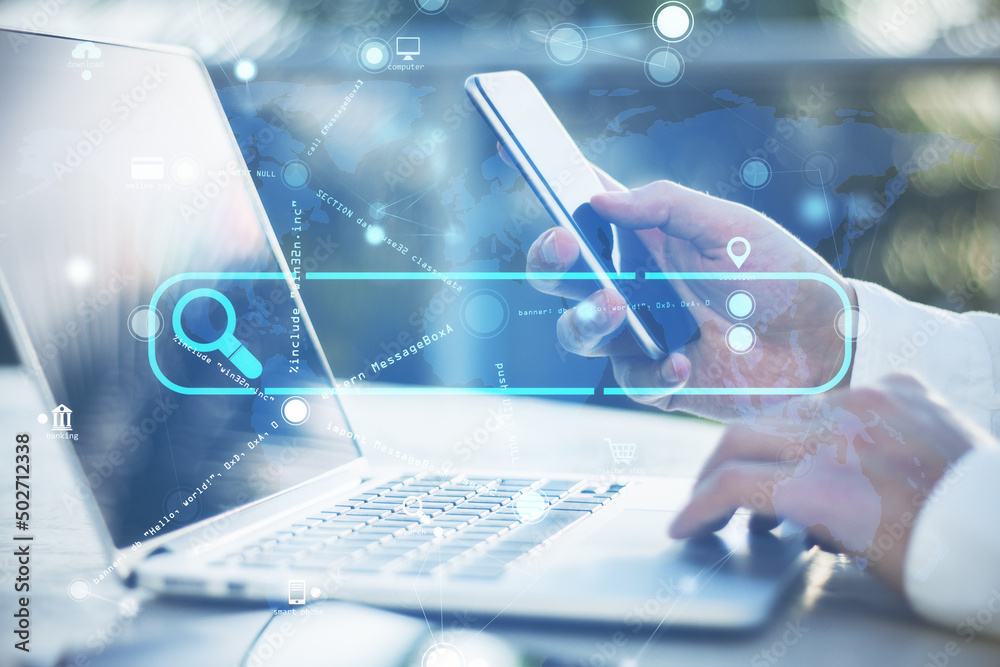 Poster close up of businessman hand using laptop and cellphone with creative search bar and digital blue ma