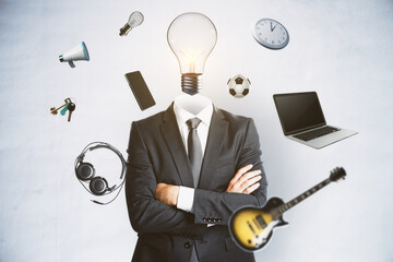 Abstract image of headless businessman with idea head, laptop, guitar and other items flying around on concrete wall background. Hobby and accupation concept.