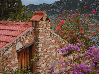 Fototapeta na wymiar Travel and tourist attractions at Kekova island, Turkey. beautiful clay house with bougainvillea flowers