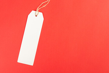 white price tag on a red isolated background, price tag for goods