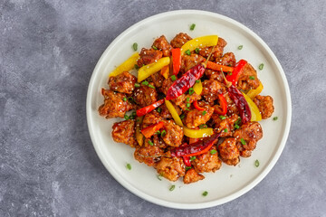Asian Stir-Fried Chicken with Bell Peppers Served on a Plate with Chopsticks Top Down Photo