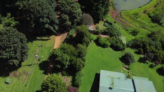 Drone shot of a horse farm in South Africa - drone is flying over the farm, revealing the mountains. Snippet could ideally be used for travel or farming related videos or South Africa movies.