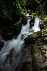 Fototapeta premium Close-up shot of a waterfall cascading down a rock in slow motion, laterite palace