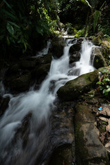 Close-up shot of a waterfall cascading down a rock in slow motion, laterite palace