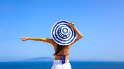 Summer blue trend with young woman in hat at  happy freedom lifestyle in Aegean sea mediterranean...