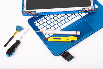 The engineer repairs blue laptop, pc, computer and the screen. laptop screen replacement. Installs...
