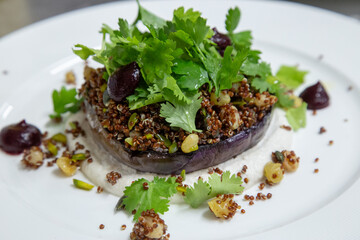 vegetarian dish with egg plant chickpeas and lentils in low light with grain and out of focus