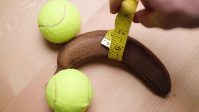 Person with measuring tape measure manhood girth of black banana with balls 4K