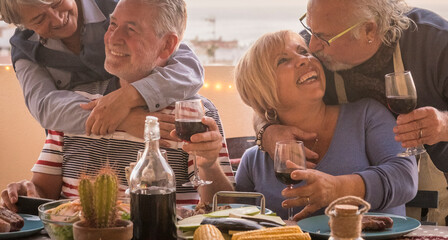 Old senior people and love friendship lifestyle celebration together in front of a table full of...