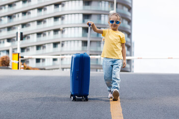 cute child with suitcase outdoor