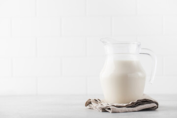 Banner jug with vegetable milk on a light background. The concept of alternative milk for a healthy lifestyle.