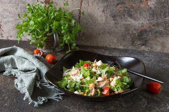 Plate With Salad With Tuna, Chickpeas And Feta On A Dark Table