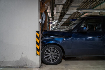 Huge SUV drove into a door in the wall in an underground parking lot at speed