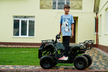 Boy in four-wheller ATV quad bike.