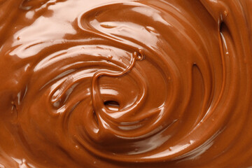 Liquid chocolate paste curl. Background of chocolate paste. Texture Close up, top view