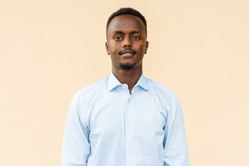 Portrait of young handsome black businessman