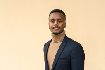 Fototapeta premium Portrait of young handsome black businessman smiling