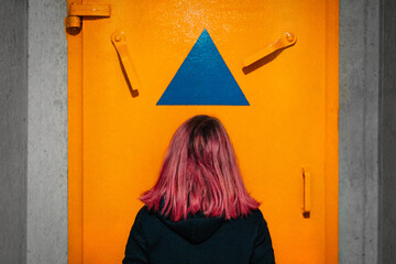 Woman  in front of bomb shelter door