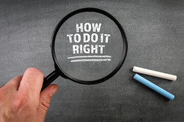 HOW TO DO IT RIGHT. Magnifying glass and white pieces of chalk on a dark blackboard background