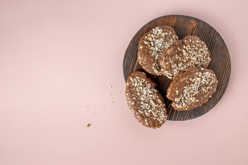 rye cakes with seeds lie on a round wooden board, copy space