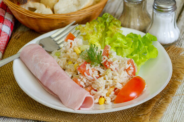 salad rice on a plate with a slice of ham