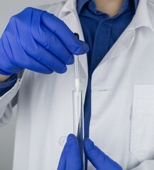 Medical laboratory assistant checks a test tube with sperm. Spermogram. Male fertility test. Semen...