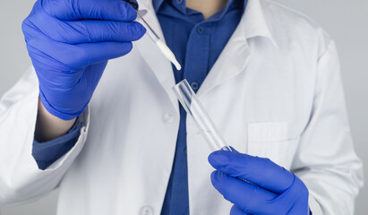 Medical laboratory assistant checks a test tube with sperm. Spermogram. Male fertility test. Semen in a test tube. Reproductive system check. Donor suitability test for artificial insemination