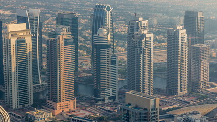JLT skyscrapers near Sheikh Zayed Road aerial timelapse. Residential buildings and villas behind
