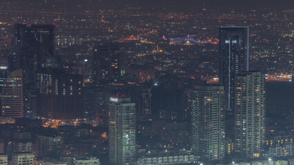Fototapeta na wymiar Dubai Aerial view showing greens and al barsha heights district area night timelapse