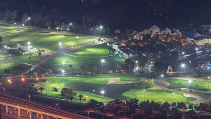 Aerial view to Golf course with green lawn and lakes night timelapse.