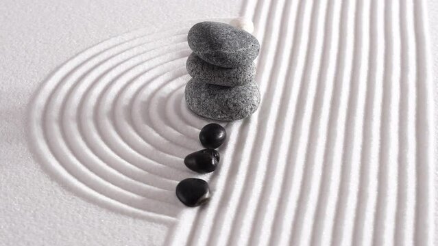 yin yang stone in Japanese garden with textured sand